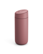 The Fellow Carter Slide Mug is a matte pink reusable travel mug with a rounded lid.