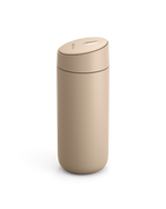 Fellow Carter Slide Mug in beige with oval push-button lid on a white background.