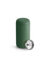 Fellow Carter Move Mug in matte green with matching lid and metal strainer beside it.