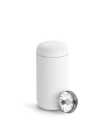 A Fellow Carter Move Mug with a metal lid sits beside it on a plain background.