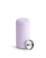 A light purple Fellow Carter Move Mug with a metal strainer leaning against it.