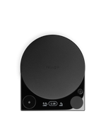 The Fellow Tally™ Pro Studio is a black coffee scale with a round platform and lit digital display.